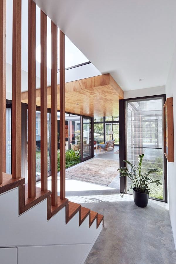 Modern Foyer with Wooden Staircase Slats and A View Into a Bright Courtyard — Fineworx Joinery in Warnervale, NSW