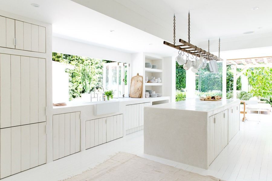 Bright White Modern Kitchen with Island and Greenery Visible Through Large Windows — Fineworx Joinery in Warnervale, NSW