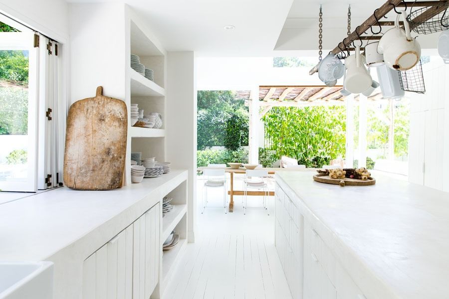 Bright White Kitchen with Island and Open View to A Sunlit Dining Area and Garden — Fineworx Joinery in Warnervale, NSW