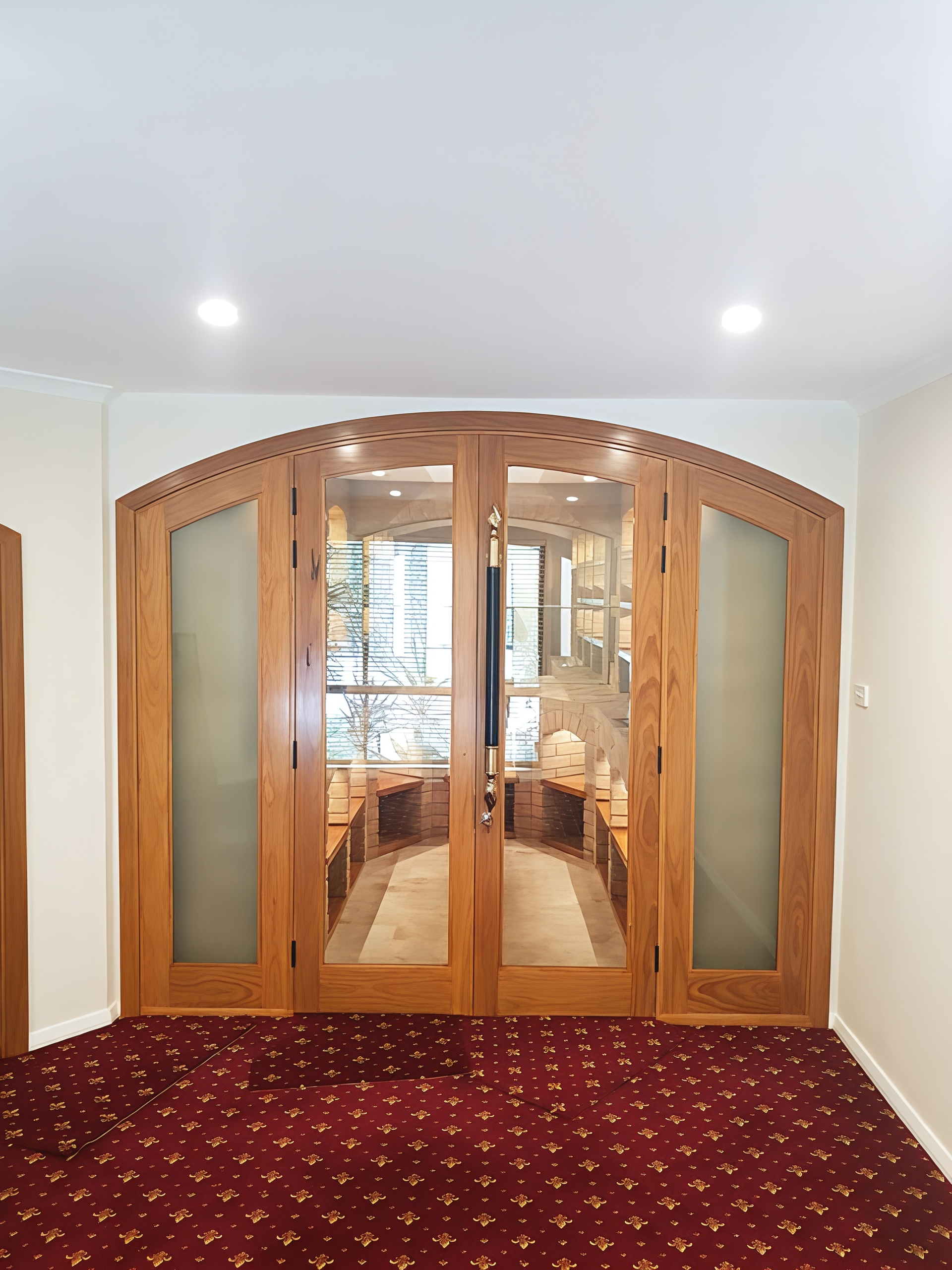 Wooden Double Doors with Frosted Glass Panels in A Carpeted Hallway — Fineworx Joinery in Warnervale, NSW