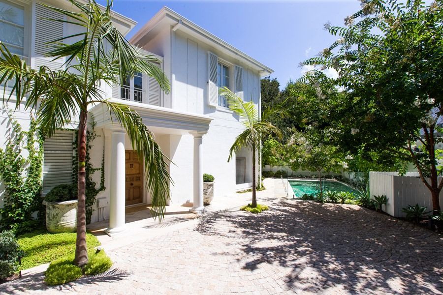 White Two Story House with Palm Trees and a Gravel Driveway — Fineworx Joinery in Warnervale, NSW