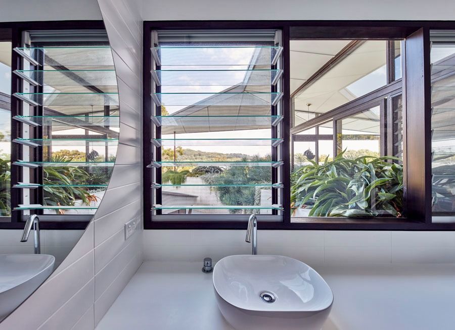 Interior with A Light Wood Sliding Barn Door Beside a Wooden Entry Door — Fineworx Joinery in Warnervale, NSW