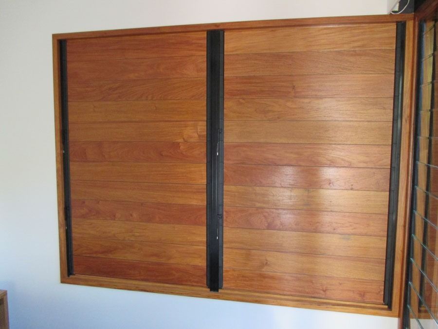 Wooden Sliding Door Panels with A Black Vertical Handle — Fineworx Joinery in Warnervale, NSW
