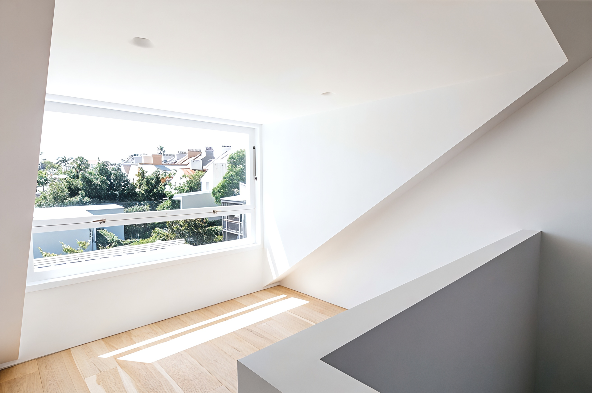 Bright Minimalist Stairwell with A Large Window Overlooking Trees and Rooftops — Fineworx Joinery in Warnervale, NSW