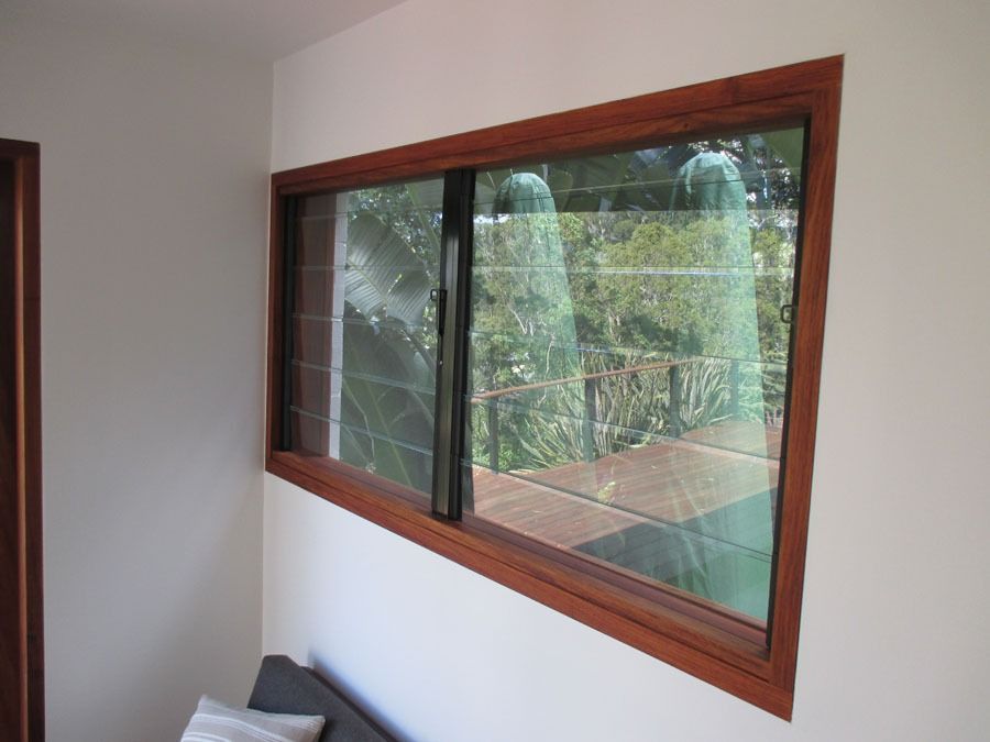 Interior Room Wall with A Large Wooden Framed Window Overlooking Greenery Outside — Fineworx Joinery in Warnervale, NSW