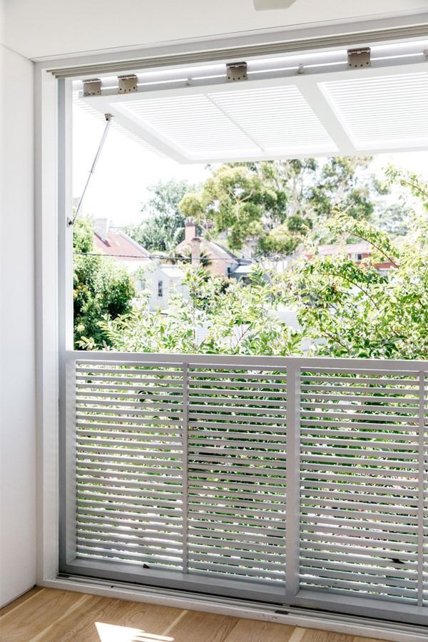 Sliding Glass Door Opening to A Bright Balcony with White Lattice Railing — Fineworx Joinery in Warnervale, NSW