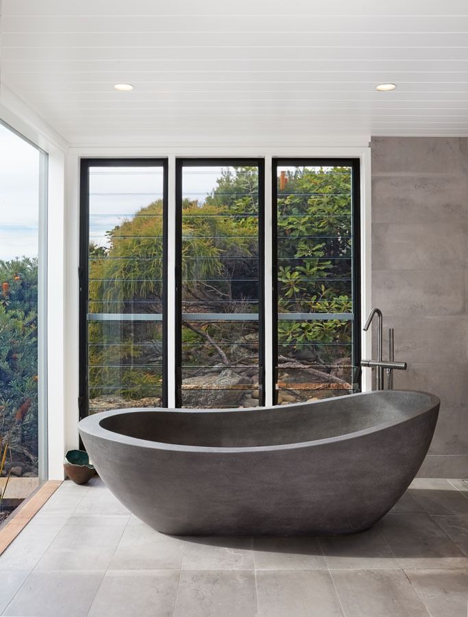 Modern Bathroom with A Freestanding Grey Tub Beside Floor To Ceiling Windows — Fineworx Joinery in Warnervale, NSW