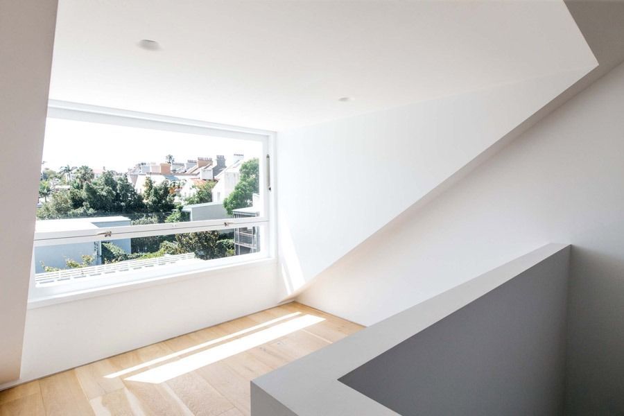 Bright Empty White Room with Large Window and Slanted Ceiling — Fineworx Joinery in Warnervale, NSW