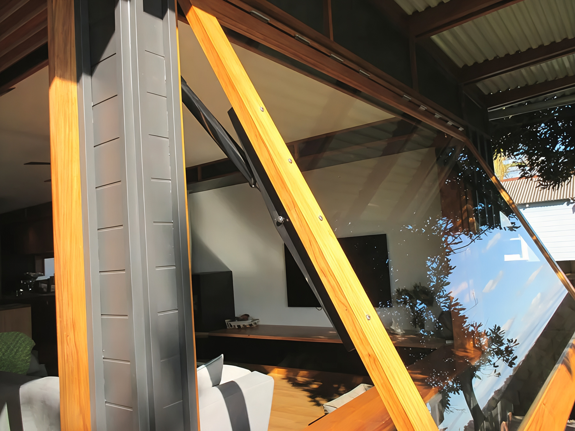 Yellow and Grey Metal Frame Beside a Reflective Glass Window — Fineworx Joinery in Warnervale, NSW