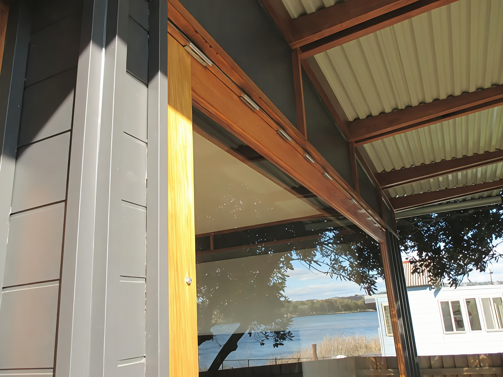 Modern House Exterior with Wooden Beam and Glass Window — Fineworx Joinery in Warnervale, NSW