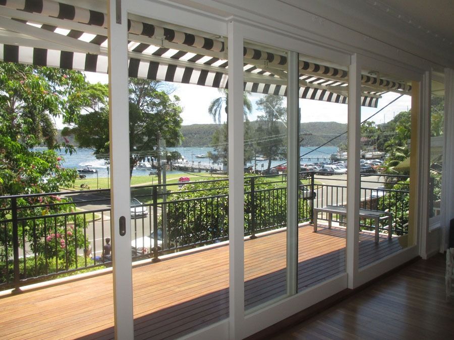 Bright Living Room with Sliding Glass Doors Opening to A Sunny Deck and Ocean View — Fineworx Joinery in Warnervale, NSW