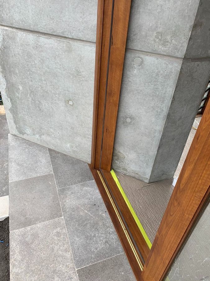 Close Up of A Doorway Threshold with A Yellow Tactile Strip and Wooden Frame — Fineworx Joinery in Warnervale, NSW