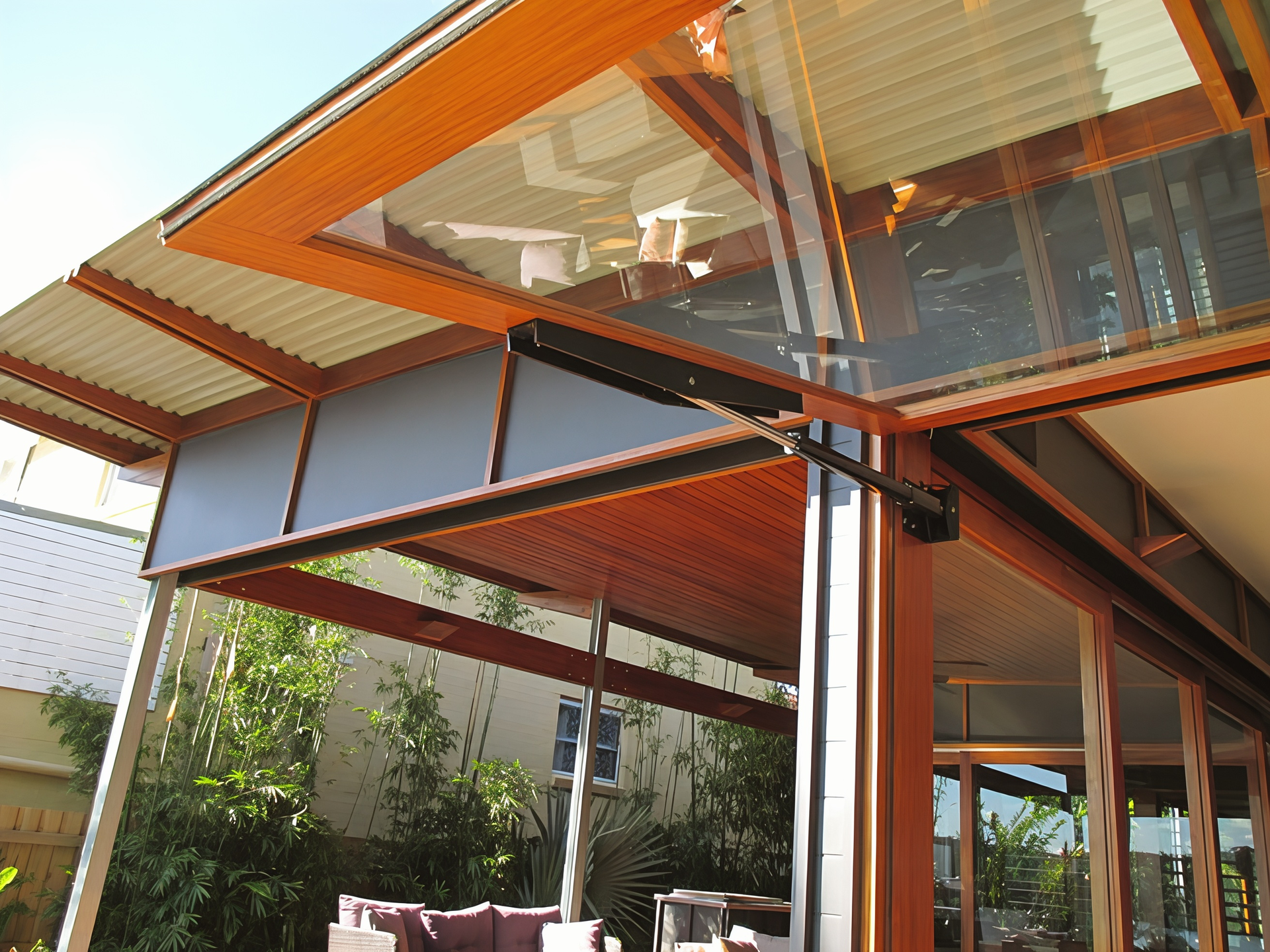 Modern House with Orange Roof Overhangs and Large Glass Windows on A Sunny Day — Fineworx Joinery in Warnervale, NSW