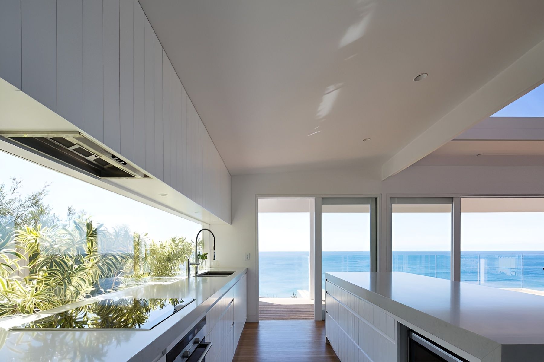 Bright Modern Kitchen with Ocean View and Large Windows Opening to A Balcony — Fineworx Joinery in Warnervale, NSW