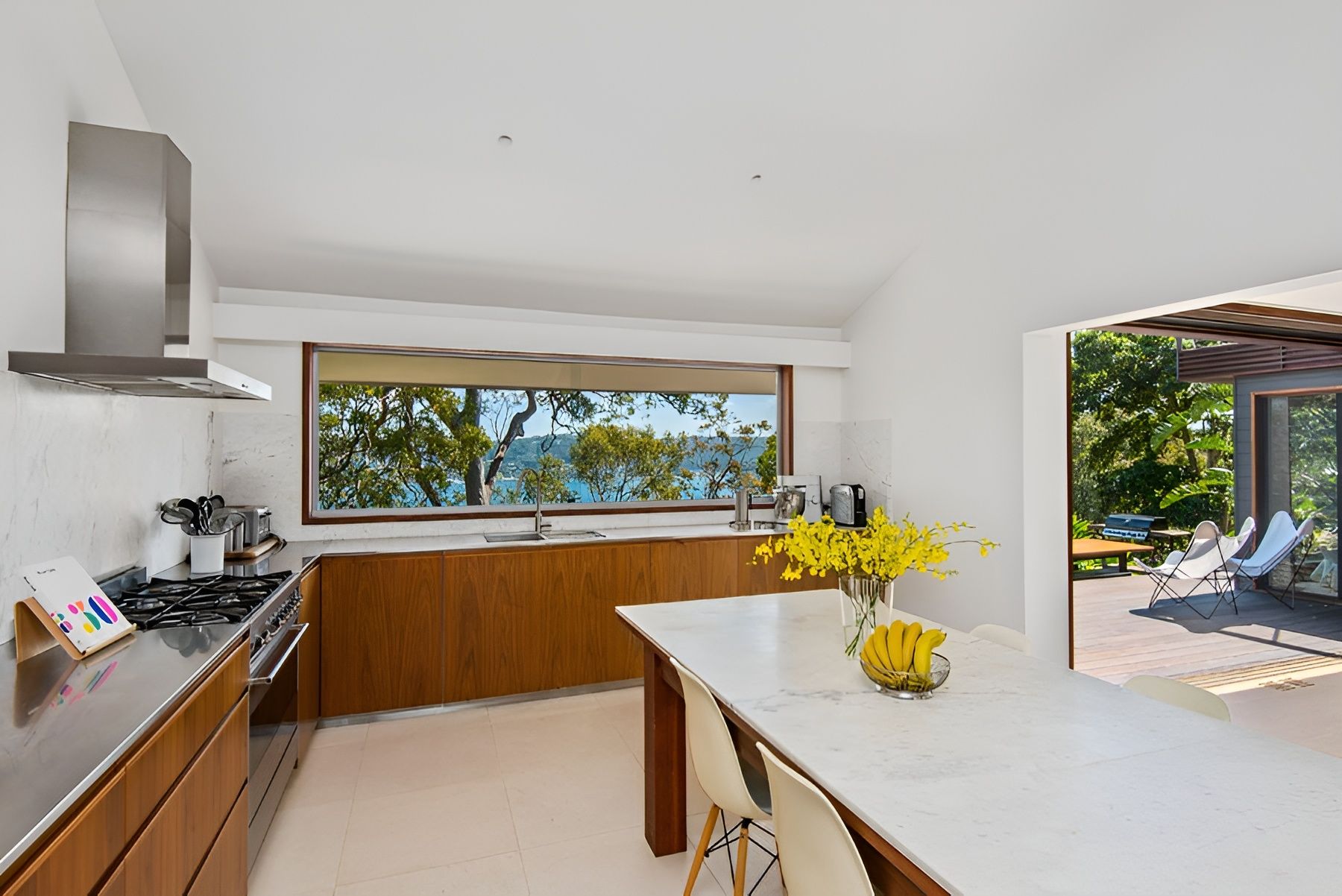 Modern Kitchen with White Island and Open Patio View — Fineworx Joinery in Sydney, NSW