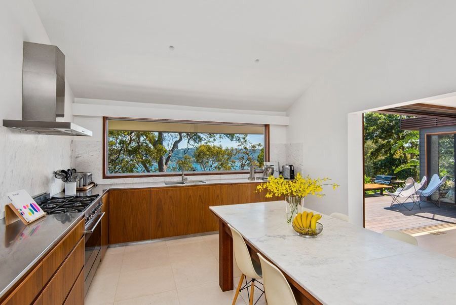 Bright Modern Kitchen with Island and Open View to Patio — Fineworx Joinery in Warnervale, NSW