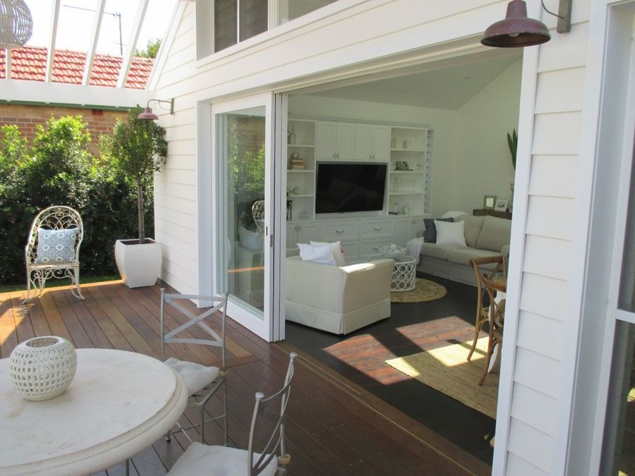 Patio with Round Table and Open Sliding Doors — Fineworx Joinery in Warnervale, NSW