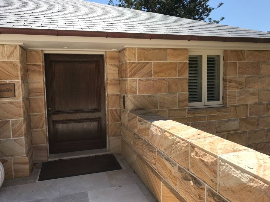 Front Porch Entry with A Dark Wooden Door and A Window with Shutters — Fineworx Joinery in Warnervale, NSW