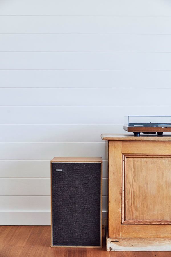 A Small Speaker Beside a Wooden Cabinet Against a White Paneled Wall — Fineworx Joinery in Warnervale, NSW