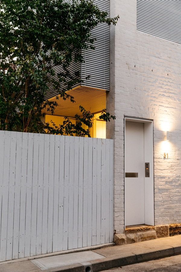 White Gate and Door on A Modern Home Exterior at Dusk — Fineworx Joinery in Warnervale, NSW