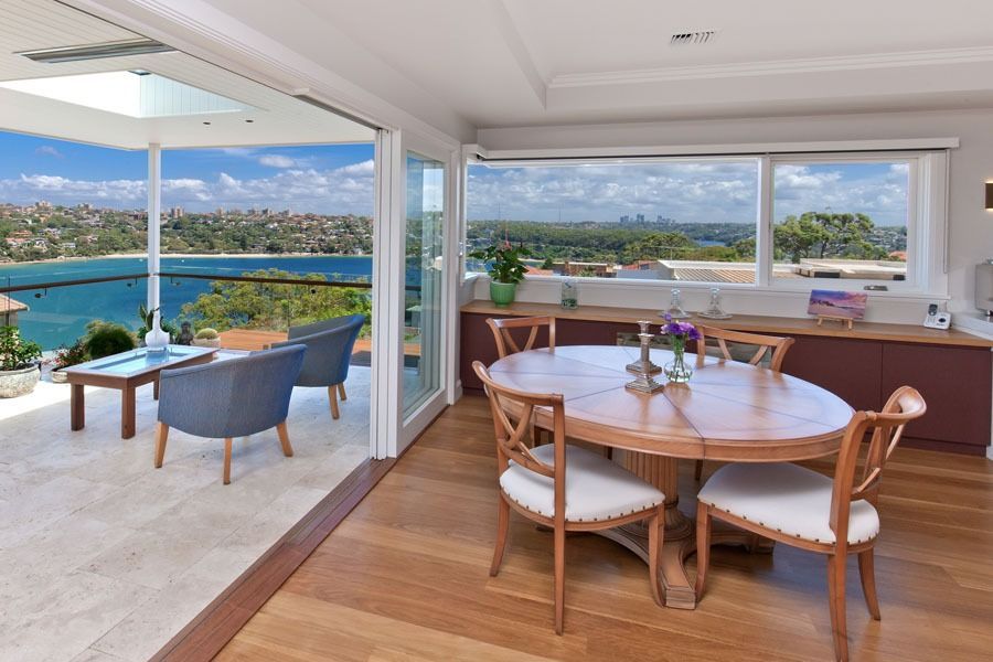 Bright Waterfront Dining Room with Wood Table — Fineworx Joinery in Warnervale, NSW