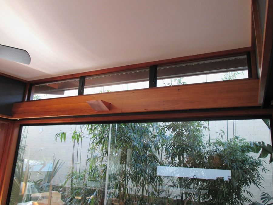 Wood-Framed Window and Glass Wall Overlooking Dense Green Plants and Trees — Fineworx Joinery in Warnervale, NSW