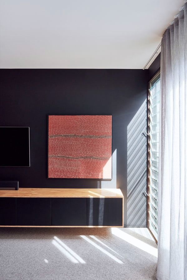 Modern Room with Dark Wall with Red Artwork and Bright Sunlight Through Window Blinds — Fineworx Joinery in Warnervale, NSW