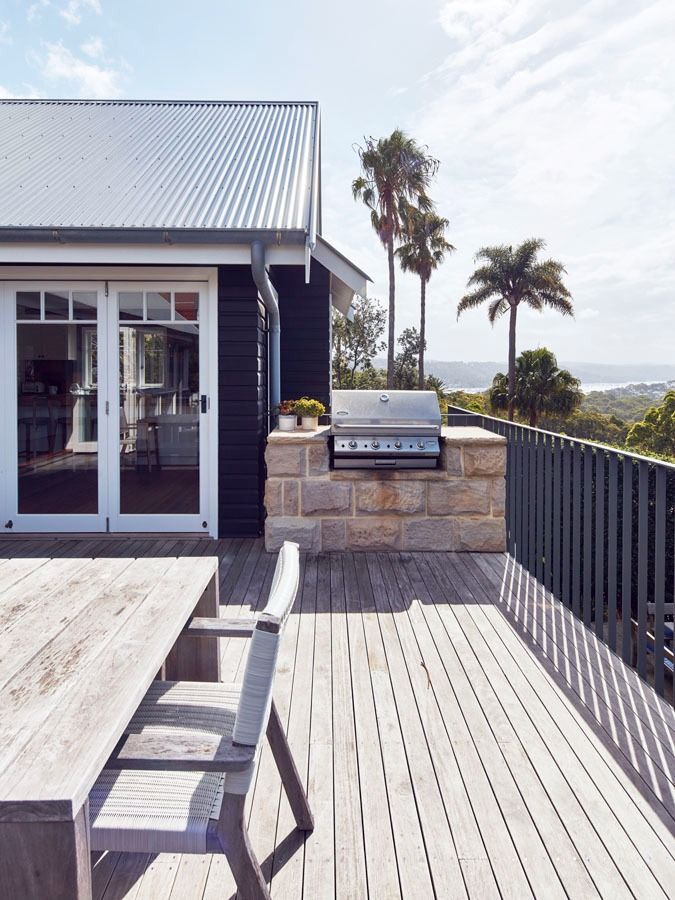 Wooden Deck with Grill Beside a Dark House and A Distant Ocean View — Fineworx Joinery in Warnervale, NSW