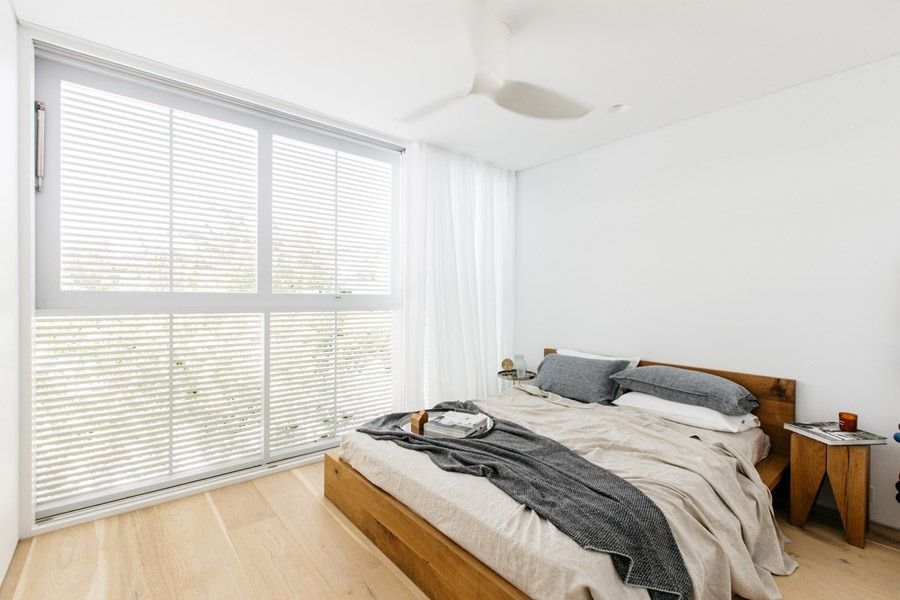Bright Bedroom with Wooden Bed and Large Window Blinds — Fineworx Joinery in Warnervale, NSW