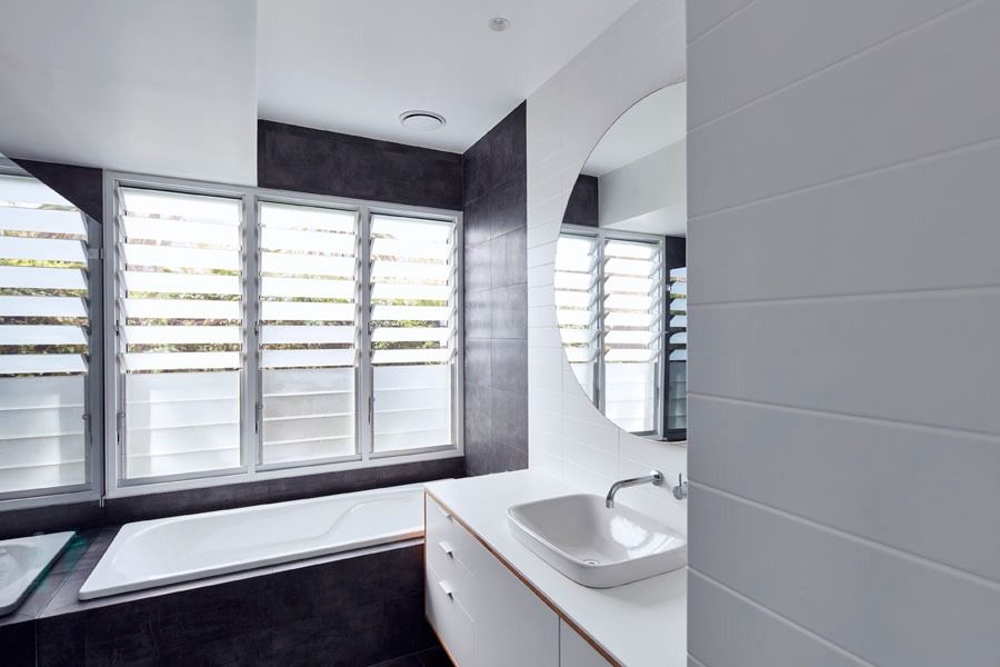 Modern Bathroom with White Vanity and Large Louvered Windows — Fineworx Joinery in Warnervale, NSW
