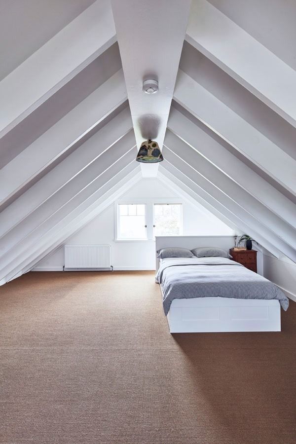 Spacious White Attic Bedroom with Two Beds and A Window at The Far End — Fineworx Joinery in Warnervale, NSW