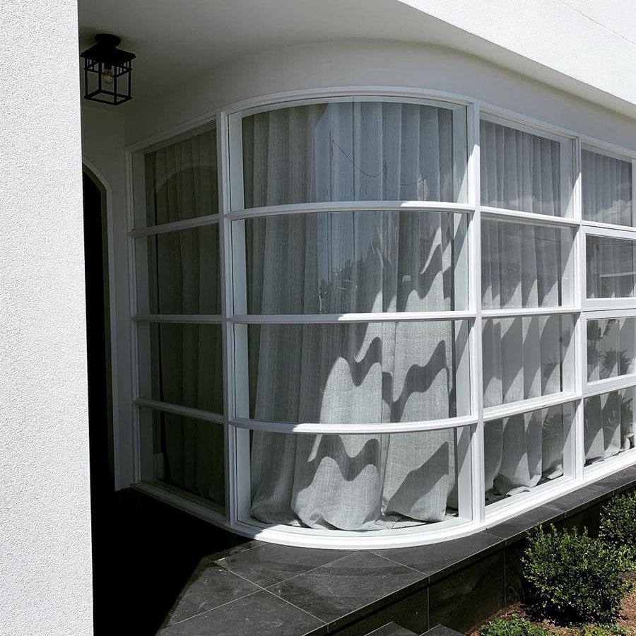 Curved White House Window with Sheer Curtains — Fineworx Joinery in Warnervale, NSW