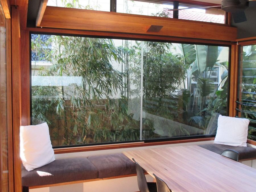 Cozy Indoor Lounge with Large Windows and A Low Table Overlooking Greenery — Fineworx Joinery in Warnervale, NSW