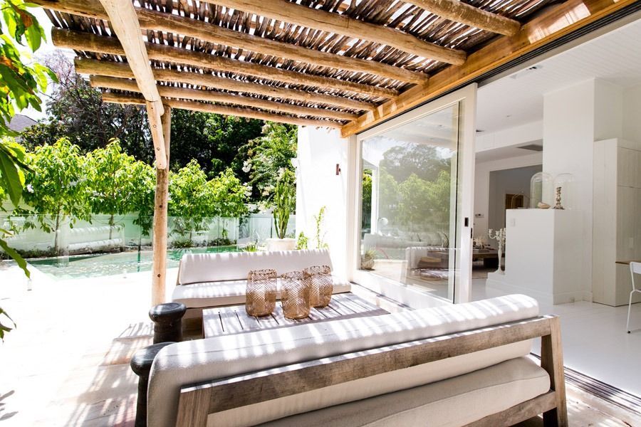 Outdoor Patio with Sliding Glass Doors Beside a Pool and Garden — Fineworx Joinery in Warnervale, NSW