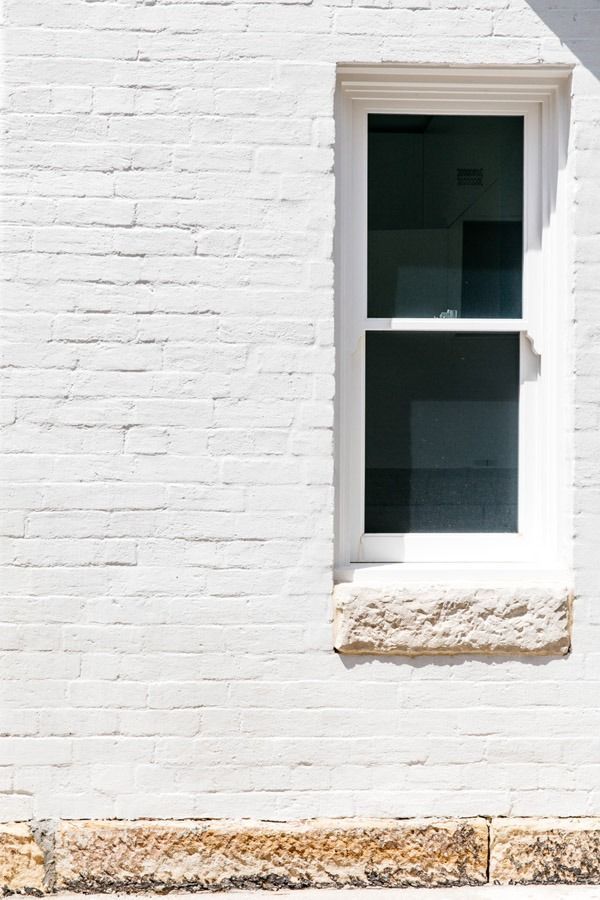 White Brick Wall with A Narrow Window and Stone Ledge — Fineworx Joinery in Warnervale, NSW