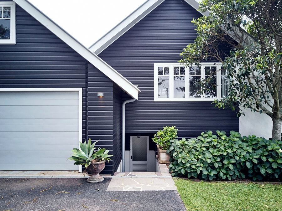 Dark Blue House Exterior with Garage and White Trimmed Windows — Fineworx Joinery in Warnervale, NSW