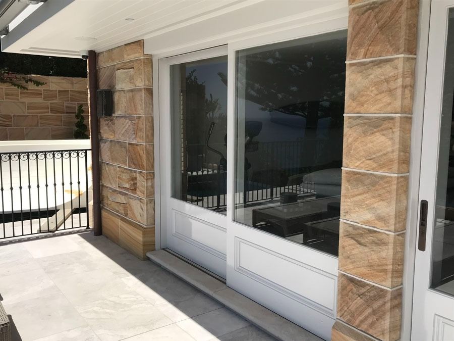 Patio with Large Sliding Glass Doors and A Railing in The Foreground — Fineworx Joinery in Warnervale, NSW