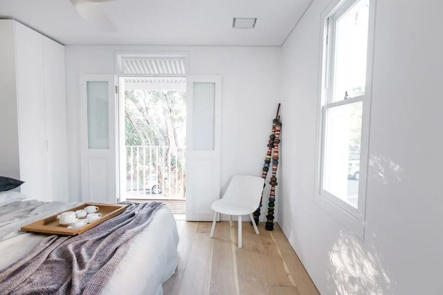 Bright Minimalist Bedroom with White Walls and Tall Windows — Fineworx Joinery in Warnervale, NSW