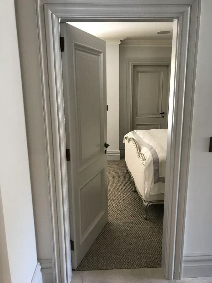 Narrow Hallway with Open White Doors Leading to A Bedroom with A Bed in View — Fineworx Joinery in Warnervale, NSW