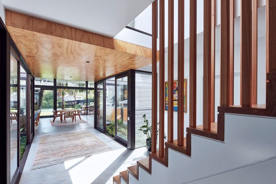 Modern Home Entry with Glass Walls and A Staircase with Vertical Slat Railing — Fineworx Joinery in Warnervale, NSW