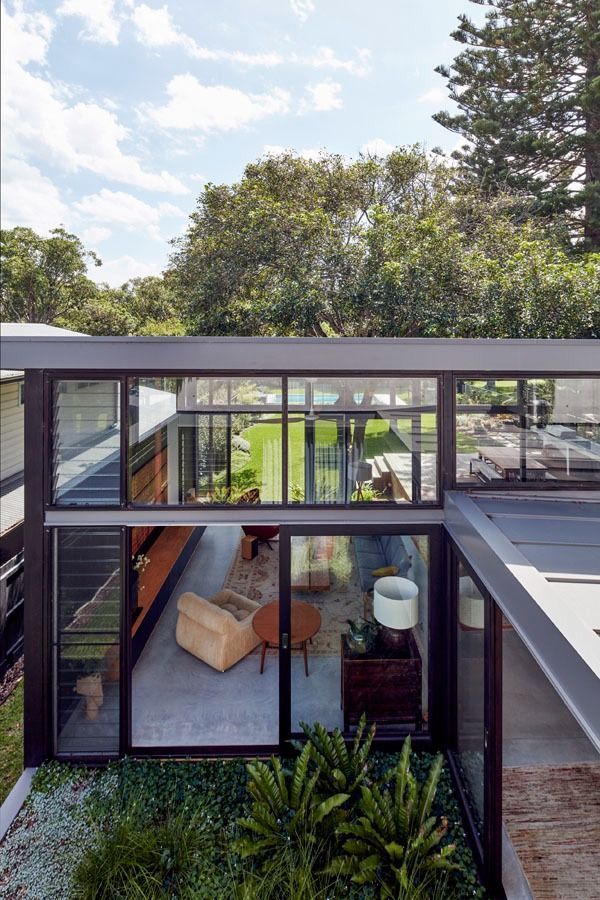 Modern Glass Walled Home with A Rooftop View of A Bright Living Room — Fineworx Joinery in Warnervale, NSW