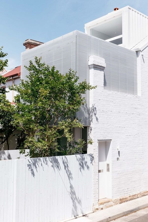 Modern White House with Patterned Upper Facade and A White Fence by The Street — Fineworx Joinery in Warnervale, NSW