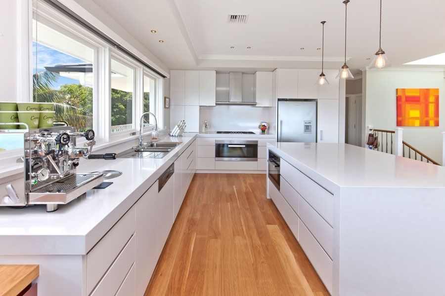 Bright Modern White Kitchen with Island and Stainless Steel Appliances — Fineworx Joinery in Warnervale, NSW