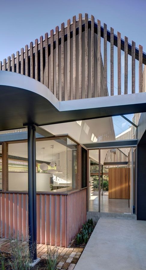 Modern House Entrance with Glass Walls and A Curved White Canopy — Fineworx Joinery in Nambucca Heads, NSW