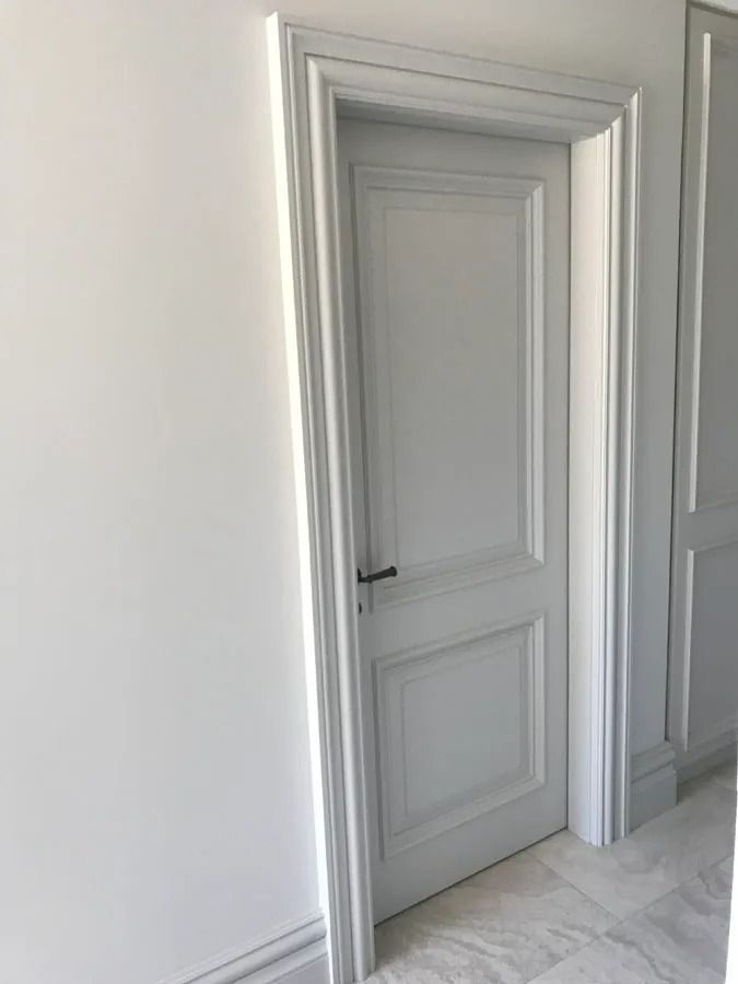 Open White Paneled Door in A Bright Hallway with Gray Trim and Light Tile Floor — Fineworx Joinery in Warnervale, NSW