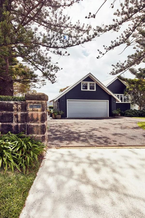 Driveway Leading to A Dark Blue House with A Garage — Fineworx Joinery in Warnervale, NSW