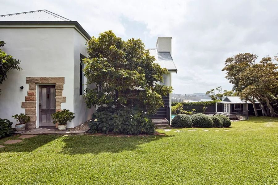 White House with Stone Doorway and Large Green Lawn — Fineworx Joinery in Warnervale, NSW