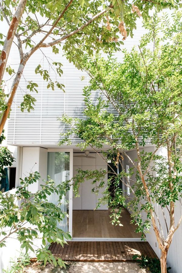 Small Modern House Facade with Sliding Glass Doors and Trees in Front — Fineworx Joinery in Warnervale, NSW