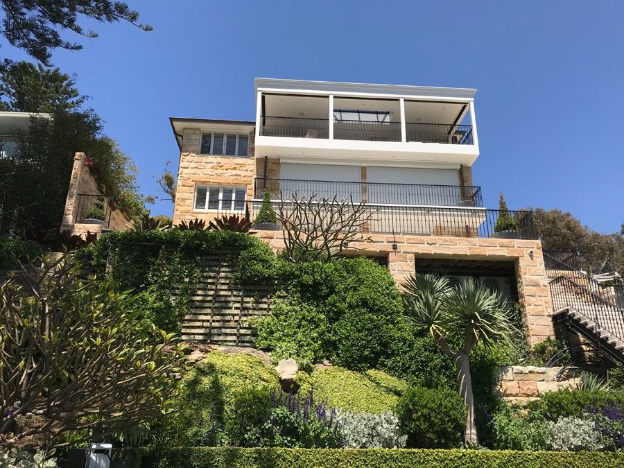 Modern Hillside House with Large Glass Windows — Fineworx Joinery in Warnervale, NSW