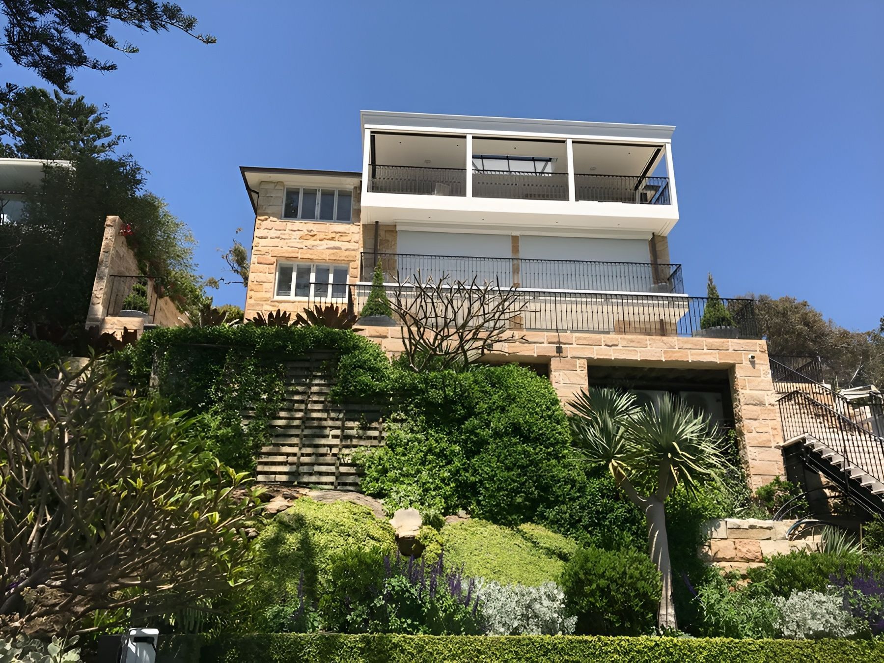Multi Story Hillside House with Stone Facade, Greenery and A Staircase — Fineworx Joinery in Warnervale, NSW